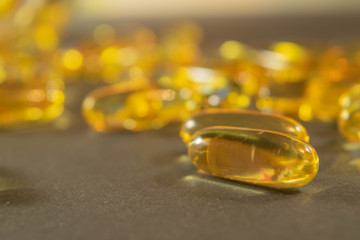 Gelatin capsules with the medicine are scattered across the table.