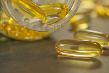 Gelatin capsules with the medicine are scattered across the table.