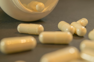 Gelatin capsules with the medicine are scattered across the table.
