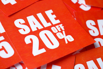 Inscriptions on sale in percentages (20) printed on red paper.