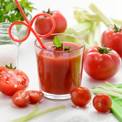 Tomato juice in glass. Tomato juice in glass with celery, cherry tomato, white wood background, closeup