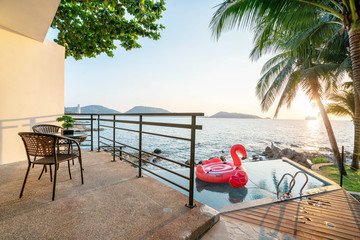 exterior swimming pool  ,floating swan  with sunset golden sky of ocean