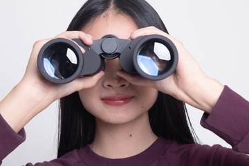 Young Asian woman with binoculars.