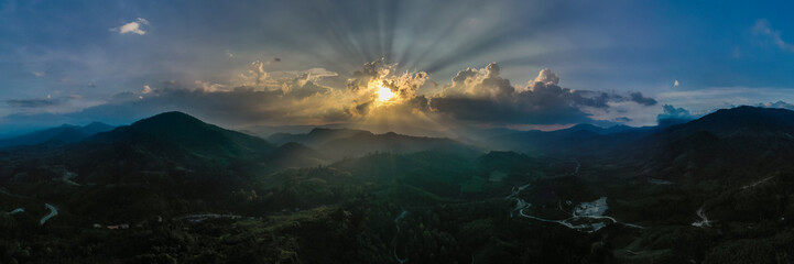 Panorama of landscape at sunset in evening light. beautiful scenery with trees in haze. Panoramic view from arial drone 