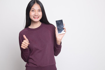 Young Asian woman show thumb up  with mobile phone.