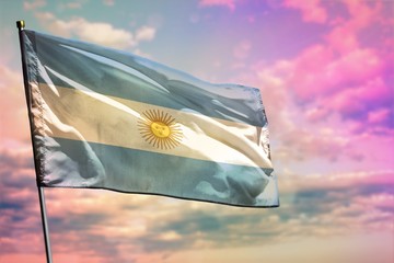 Fluttering Argentina flag on colorful cloudy sky background. Prosperity concept.