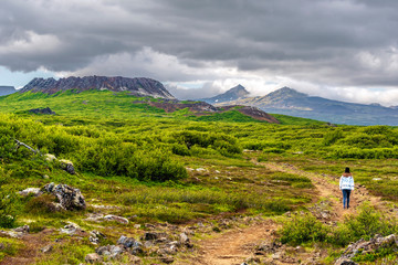 Girl teenager on the walk pass to Eldborg volcano crater in Vesturland region of Iceland. © sasha64f