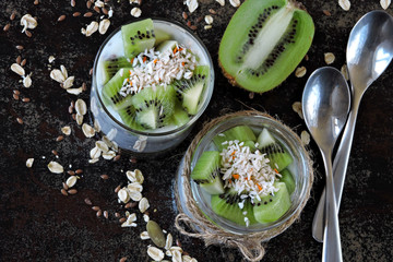 Yogurt with granola, seeds and kiwi. Healthy breakfast with probiotics. Fermented dairy products. Fitness breakfast with seeds. Flat Lay.