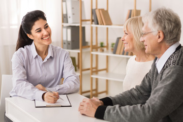 Senior couple planning investments with financial consultant