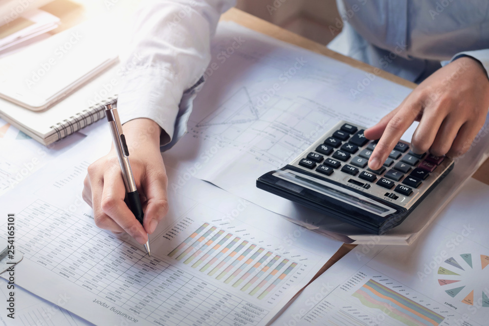 Poster finance and accounting concept. business woman working on desk using calculator to calculate in offi