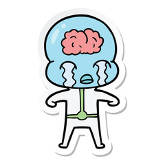 sticker of a cartoon big brain alien crying