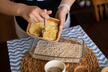 chef at work, making baked oatmeal with banana, blueberries, walnut and raisins. preparing food to bake. concept for cooking.