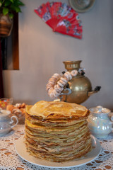 Celebration of Maslenitsa with pancakes and tea from a samovar. Slavic traditions.