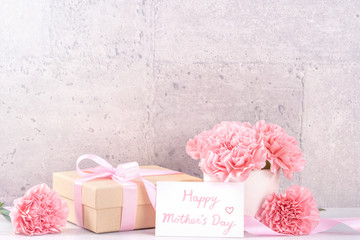 May mothers day handmade giftbox wishes photography - Beautiful blooming carnations with pink ribbon box isolated on fair-faced gray background desk, close up, copy space, mock up