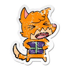 distressed sticker of a angry cartoon fox with christmas present