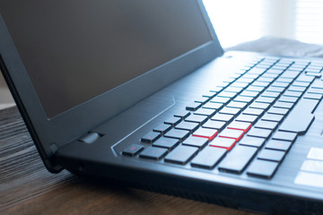 Laptop keyboard on the wood desk