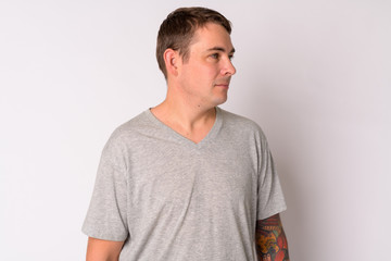 Fototapeta premium Profile view of handsome man thinking against white background