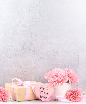 May mothers day handmade giftbox wishes photography - Beautiful blooming carnations with pink ribbon box isolated on fair-faced gray background desk, close up, copy space, mock up
