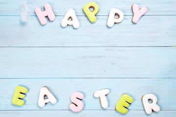 Delicious Easter cookies background. Eggs with different pattern icing on blue wooden background