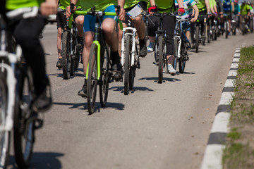 Naklejka na ściany i meble Many racing bikes. A group of cyclists riding during the street