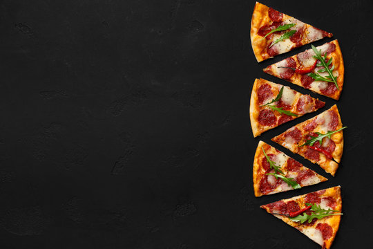 Fresh pepperoni pizza slices in row on dark background - Powered by Adobe