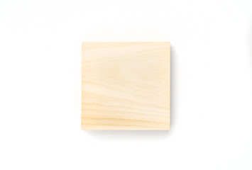 Wooden square on white background. Lumber piece close-up shot, top view, isolated.