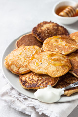 Buckwheat pancakes with honey and sour cream. Breakfast or brunch. Gluten free pancakes.