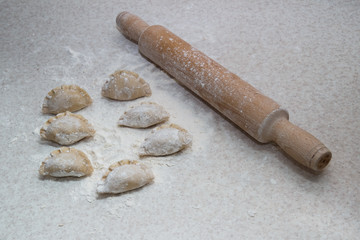 Appetizing dumplings, vareniki, ravioli, momo close-up. Boiled dough with filling. Traditional dish of Ukraine, Italy, Asia. Dumplings with meat, fish, vegetables. A hearty breakfast, lunch, dinner.