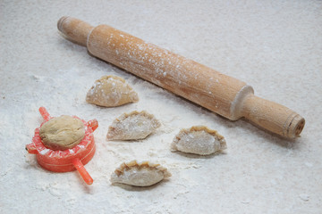 Appetizing dumplings, vareniki, ravioli, momo close-up. Boiled dough with filling. Traditional dish of Ukraine, Italy, Asia. Dumplings with meat, fish, vegetables. A hearty breakfast, lunch, dinner.