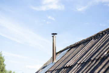 The pipe on the roof. Chimney. Country house. The house with a chimney.