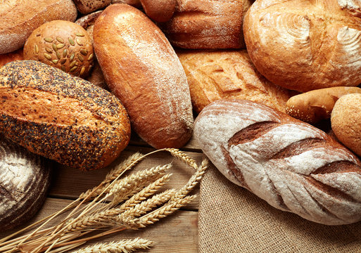 assortment of baked bread on wooden background