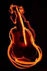 Playing with the fire traces around the acoustic guitar. 