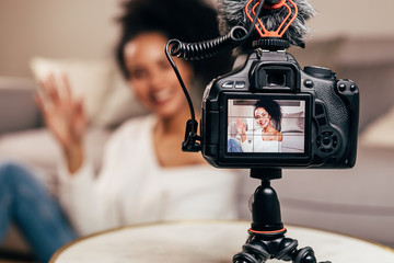 Vlogger recording content for her blog on a DSLR camera 