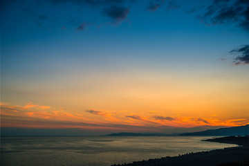Fototapeta premium Colorful sunset with dramatic sky background over sea.