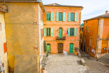  Editorial Illustrative. Roussillon Provence France. February 9, 2019. Tourist village. Ocher color houses. The deserted area and flags of the French republic. 