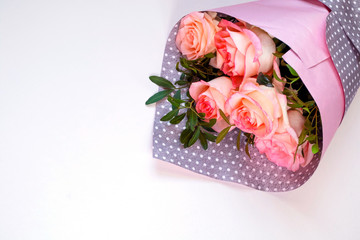 Bouquet of pink roses on light background, greeting card, place for text.