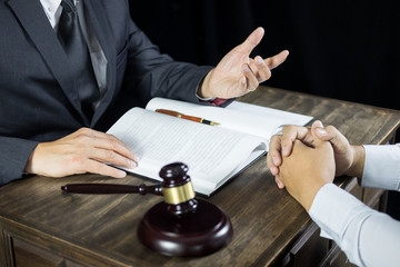 Lawyer or judge consult meeting with client at a law firm about legal legislation in courtroom with...