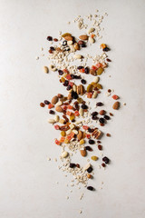 Variety of dried fruits, nuts and oat flakes for cooking homemade healthy breakfast muesli or...