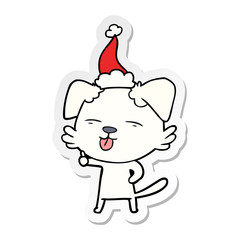 sticker cartoon of a dog sticking out tongue wearing santa hat