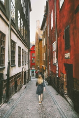 Woman walking in Stockholm traveling  lifestyle summer vacations in Sweden old city cobblestone...