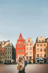 Woman tourist sightseeing Stockholm city Gamla Stan traveling lifestyle girl taking photo by...