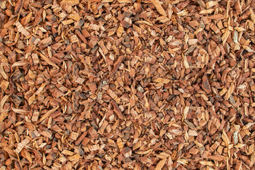 Ground oak bark. The texture of wooden sawdust. - obrazy, fototapety, plakaty