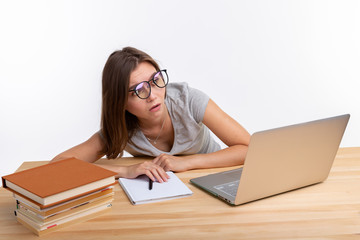 Study, education and people concept - young student woman working at laptop looking very tired