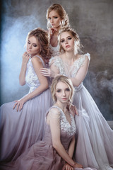 Fototapeta na wymiar Bride blonde young women in a modern color wedding dress with elegant hair style and make up. Fashion beauty portrait composition over textured background