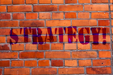 Text sign showing Strategy. Business photo text Group of ideas planned to achieve success Brick Wall art like Graffiti motivational call written on the wall