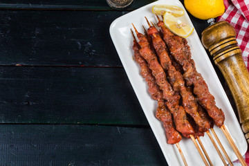 skewers shashlik kebab with red sauce,