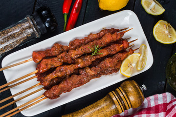 skewers shashlik kebab with red sauce,