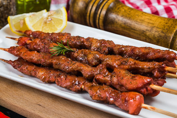 skewers shashlik kebab with red sauce,