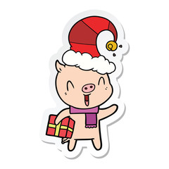 sticker of a happy cartoon pig with xmas present