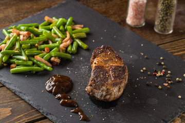 grilled steak from beef sirloin with green beans and bacon